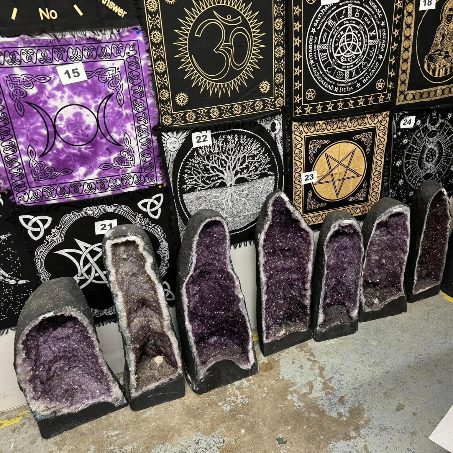 A row of rich purple amethyst cathedrals on a background of altar cloths